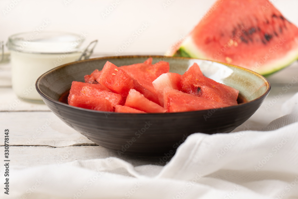Watermelon fruit cutted in bowl on white background
