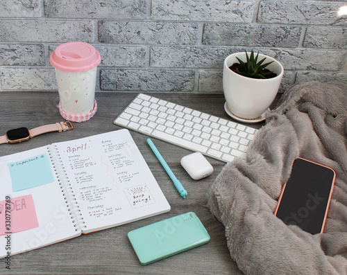 Concept layout of work place. Keyboard, planner, cup and a plant