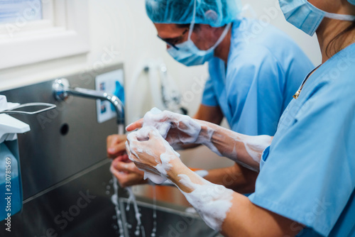 Healthcare personnel washing hands in hospital