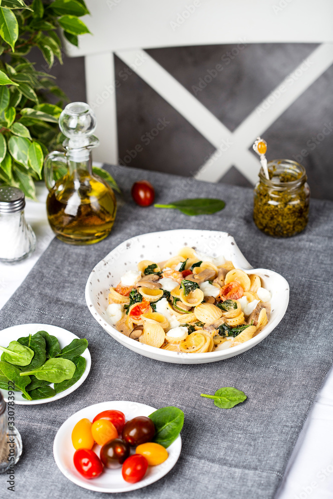 Italian orecchiette pasta with spinach and tomatos Italian orecchiette pasta with spinach and tomatos