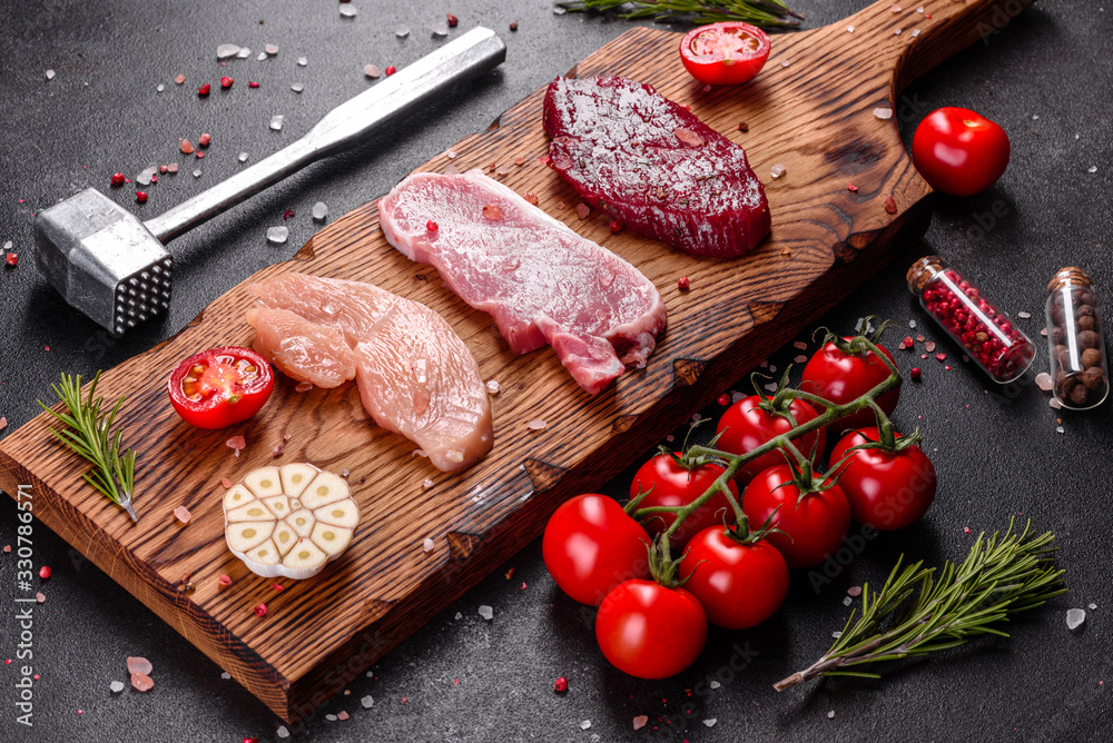 Fresh juicy steak of beef, pork and chicken with vegetables ready to cook Fresh juicy steak of beef, pork and chicken with vegetables ready to cook