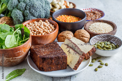 Vegan sources of protein. Tofu, chickpeas, lentils, nuts, spinach and broccoli - vegetable proteins.