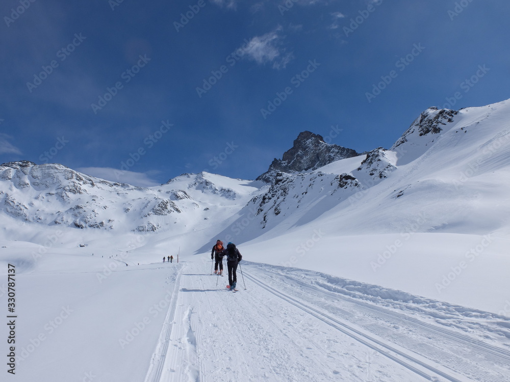 Skieurs de ski de randonnée et alpiniste en montagne qui skient sur la neige et la glace en plein soleil des alpes dans le Queyras de saint Véran