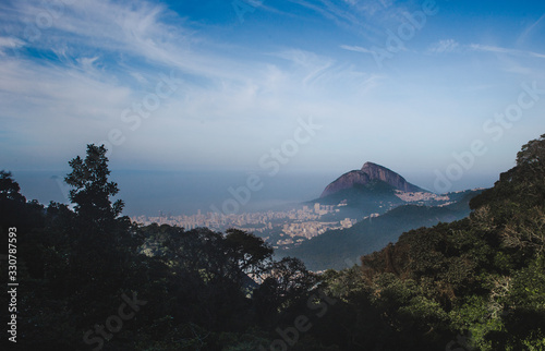 High viewpoint over the Atlantic Ocean bays and lush green mountains of the city of Rio de Janeiro, Brazil