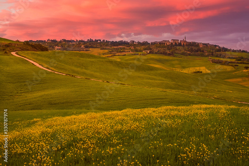 Tuscany, landscape overview on Pienza in the Val d'Orcia taken from the fields in bloom at sunset after th rain
