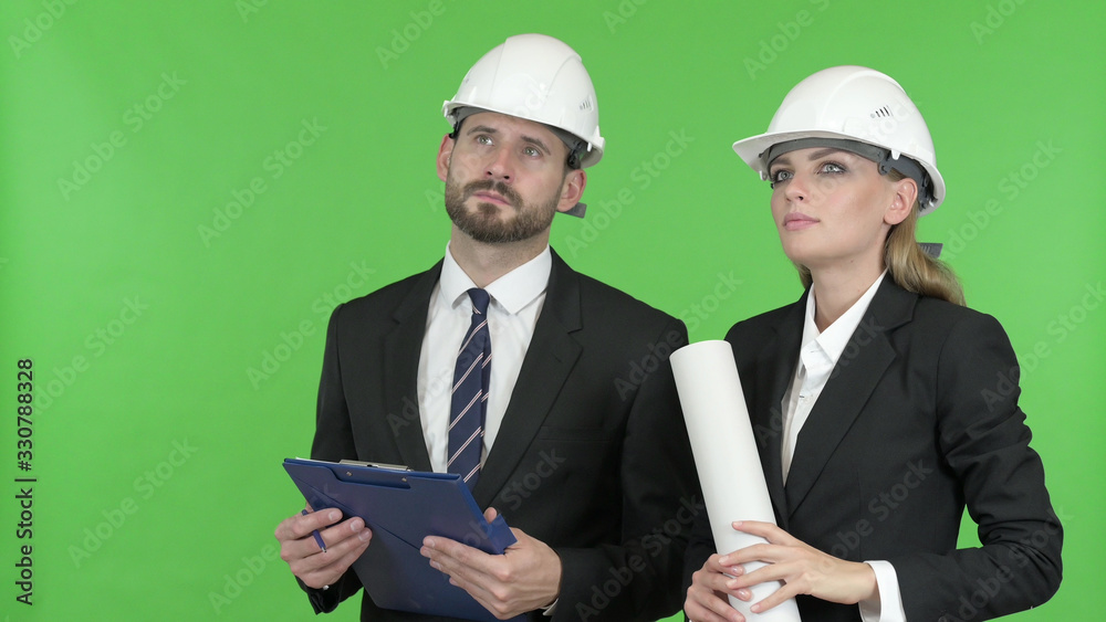 The Engineers Studying Construction Documents Against Chroma Key The Engineers Studying Construction Documents Against Chroma Key