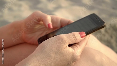 Female hands using smartphone