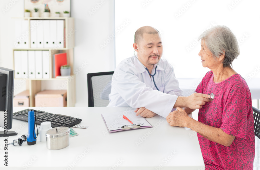 close up old asian woman, Asian doctor talk with old female patient about disease symptom, doctor use stethoscope listening lung of patient, elderly health check up close up old asian woman, Asian doctor talk with old female patient about disease symptom, doctor use stethoscope listening lung of patient, elderly health check up
