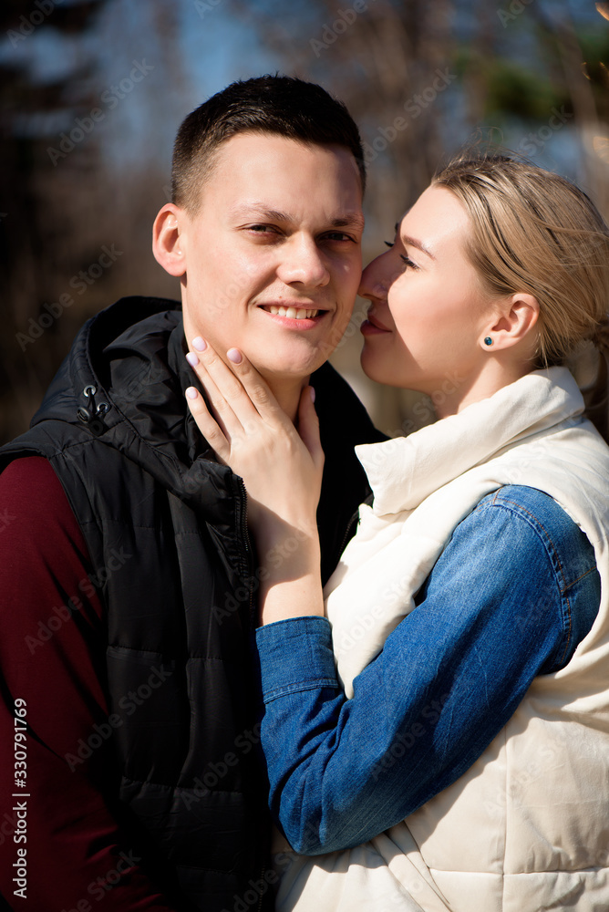 Beautiful young couple in love walks in the park. Beautiful young couple in love walks in the park.