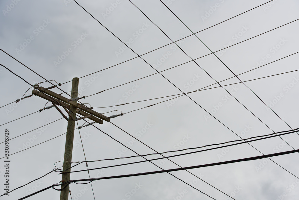 A unique pattern created by power lines against an overcast sky. A unique pattern created by power lines against an overcast sky.