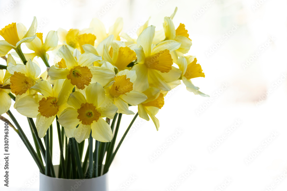 Bouquet of yellow daffodils. In a vase on the window. Spring flowers, background. Beauty