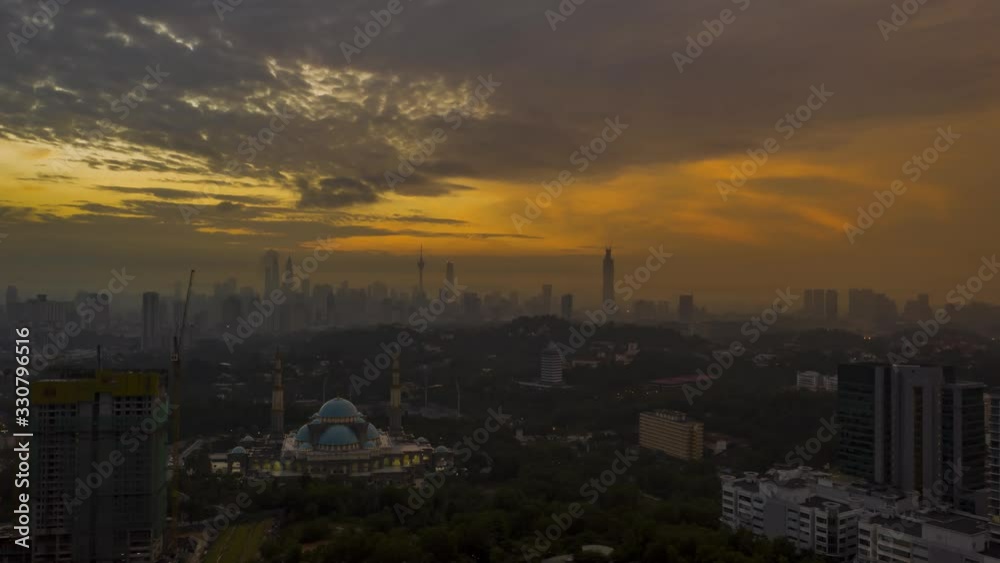 Hyperlapse : Masjid Wilayah with city skyline in the background in Kuala Lumpur, Malaysia. Night to day using drone. Hyperlapse : Masjid Wilayah with city skyline in the background in Kuala Lumpur, Malaysia. Night to day using drone.