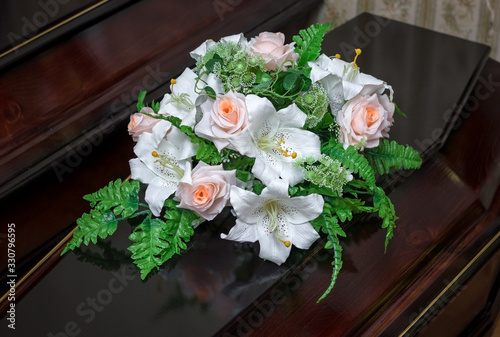 wooden coffin decorated with flowers. burial of the deceased.