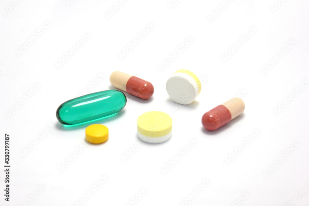 Heaps of pills and capsules isolated on white background. Medicine concept.
