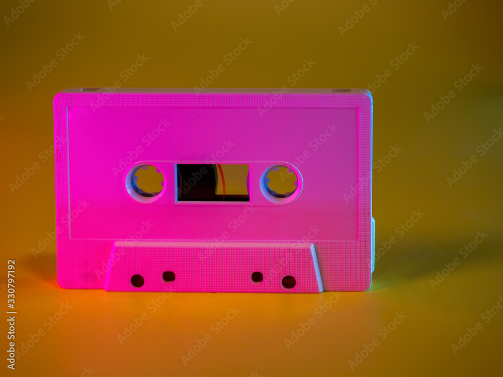 Obraz premium Audio cassette tape vintage analog recording medium from 1970's on yellow background