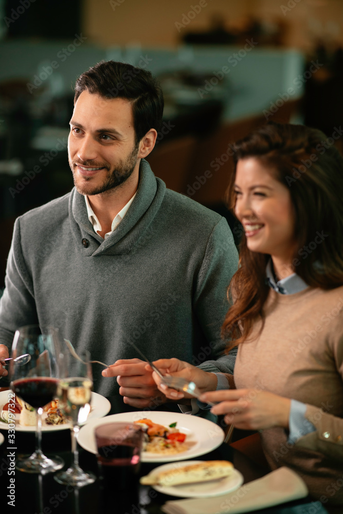 Happy loving couple enjoying in restaurant. Young couple enjoying in food. Happy loving couple enjoying in restaurant. Young couple enjoying in food.