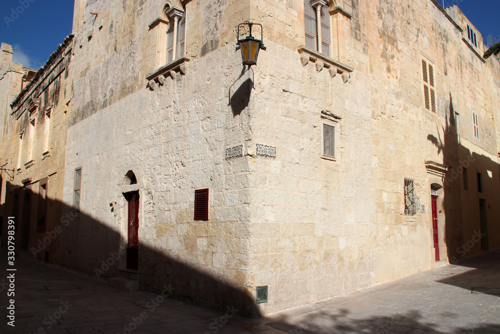 stone houses and alley in mdina (malta)