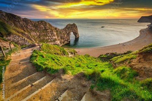 Durdle Door at the beach on the Jurassic Coast of Dorset at sunset, UK