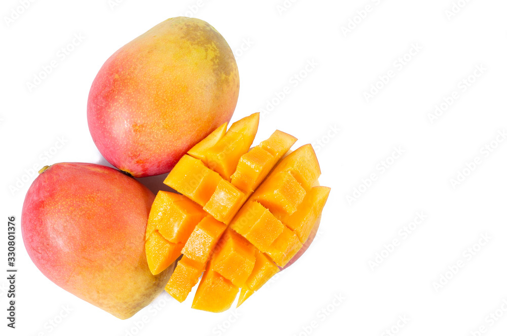 Mango cut into squares on a white background. Tropical fruit concept. Mango cut into squares on a white background. Tropical fruit concept.