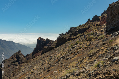Above the clouds. Aerial view of the National Park Caldera de Taburiente, volcanic crater seen from mountain peak of Roque de los Muchachos Viewpoint. La Palma, Spain