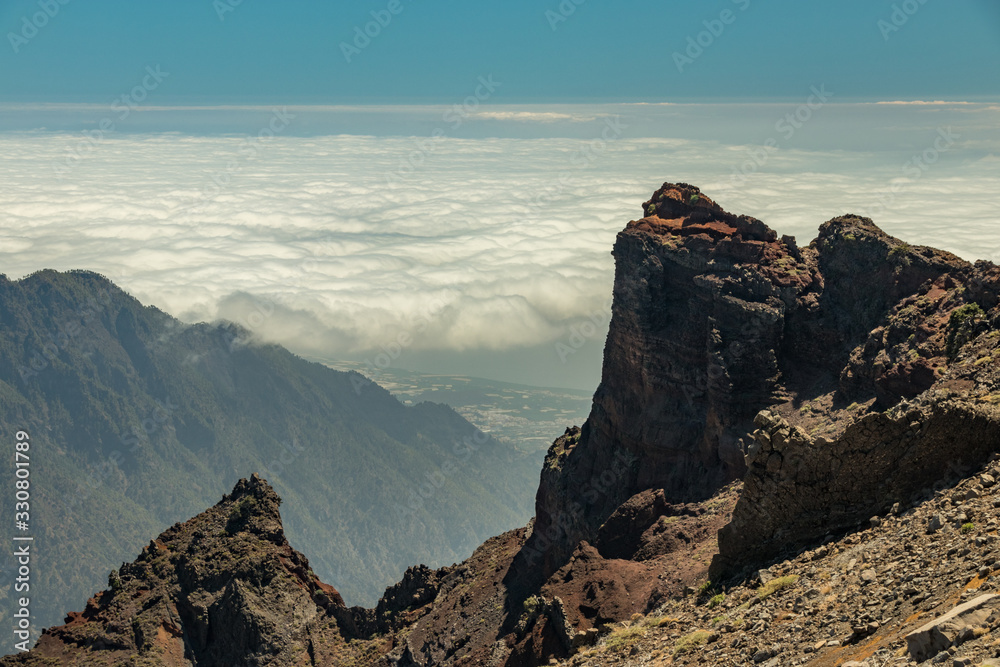 Above the clouds. Aerial view of the National Park Caldera de Taburiente, volcanic crater seen from mountain peak of Roque de los Muchachos Viewpoint. La Palma, Spain