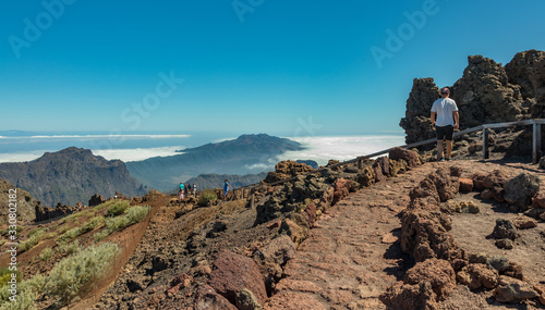 Aerial view of the National Park Caldera de Taburiente, volcanic crater seen from mountain peak of Roque de los Muchachos Viewpoint. El Hierro on horizon line above the clouds. La Palma, Spain photo