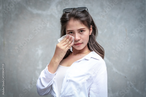 Asian beautiful woman with yellow skin, long black hair, wearing a white shirt, jeans showing her emotions.  Cement wall background-01