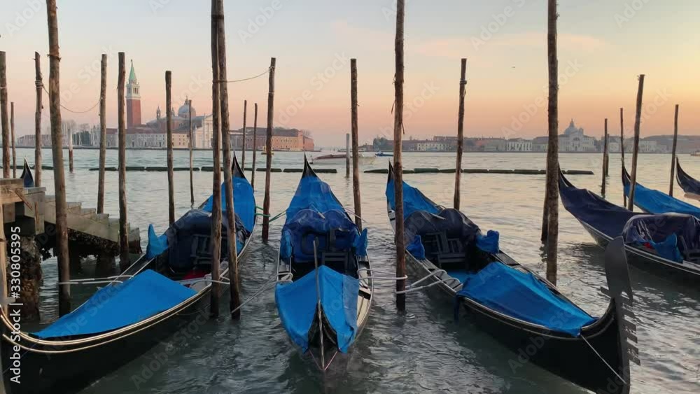 VENICE, ITALY - JANUARY 21, 2020. Boats in Venice canal. Italy winter travel, bridge and houses. Romantic destination in Europe. VENICE, ITALY - JANUARY 21, 2020. Boats in Venice canal. Italy winter travel, bridge and houses. Romantic destination in Europe.