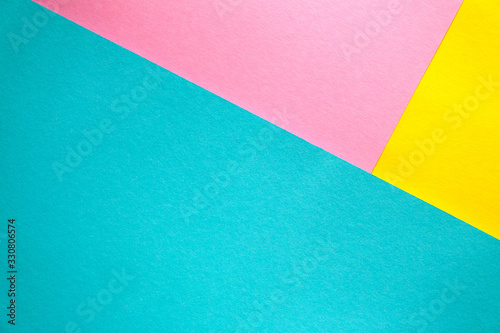 Colored paper lying on top of each other. Pink, blue, yellow thick paper. Colored bright paper background.