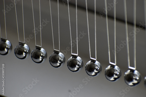 Business concept for strategy team work and alignment. Newtons Cradle Pendulum.