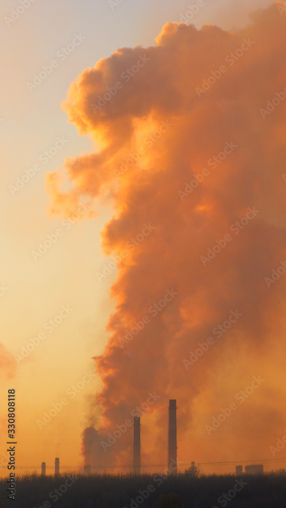 Epic pollution concept. Cloud of harmful substances. Vertical. Metallurgical factory background.