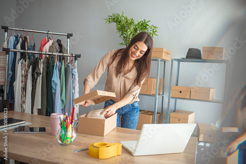 Young woman small business owner working at home office. Online marketing packaging delivery, startup SME entrepreneur or freelance woman concept. Small business owener photo