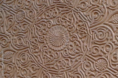 Close-up of beautiful crafted carving / ornaments on a wooden flat table; Morocco, Africa