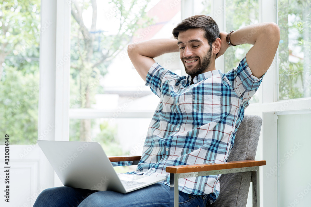 Freelance and working online, The young man is working with a laptop over the internet at home. Freelance and working online, The young man is working with a laptop over the internet at home.