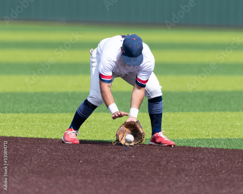 Young Boy catching and throwing the ball during a competitive baseball game