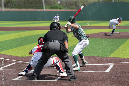 Young boy swinging the bat for a hit in a baseball game