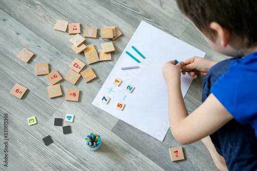 Close-up of children's hands. solving mathematics examples. Educational and school concept. 