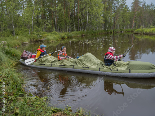 Family in kayak. Active extreme holidays in Karelia. Ecotourism, visiting fragile, pristine, and relatively undisturbed natural areas