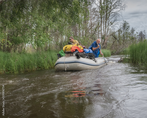 Rafting along a wild narrow river in Karelia. Active holidays in Karelia. Ecotourism, visiting fragile, undisturbed natural areas