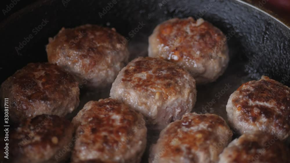 Home cooking. Roasting the meatballs in sunflower oil in a cast iron skillet. Home cooking. Roasting the meatballs in sunflower oil in a cast iron skillet.