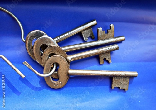 A close-up view of keys resting on blue paper.