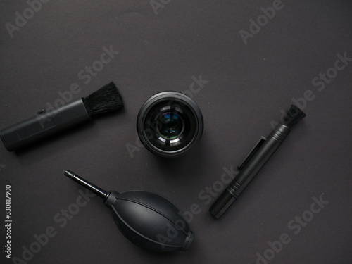 Camera cleaning kits and camera gears on colored background