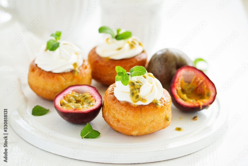 Rum woman (brioche) with cream and passion fruit. Dessert. Selective focus Rum woman (brioche) with cream and passion fruit. Dessert. Selective focus