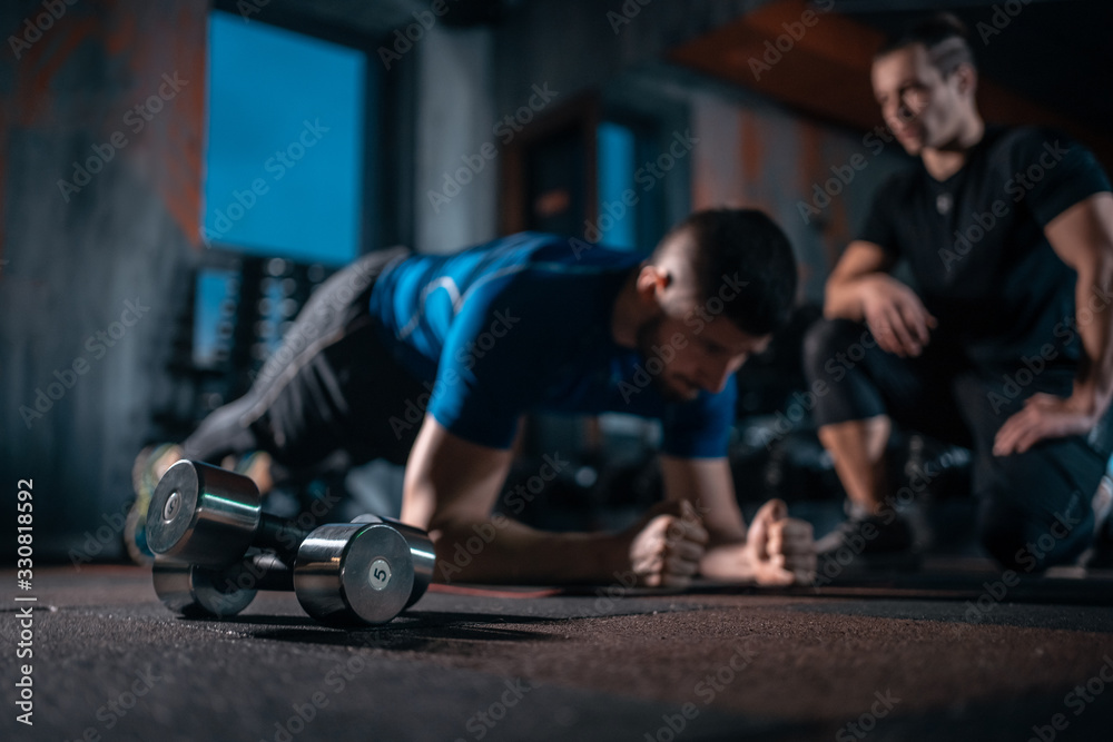 Fotobehang Persoonlijk young man has workout with personal trainer in modern gym #330818592