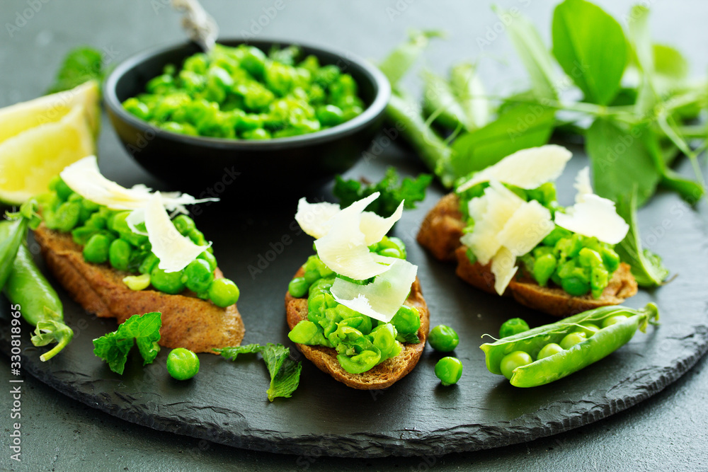 Crostini with pea puree, mint and parmesan. Snack. Crostini with pea puree, mint and parmesan. Snack.