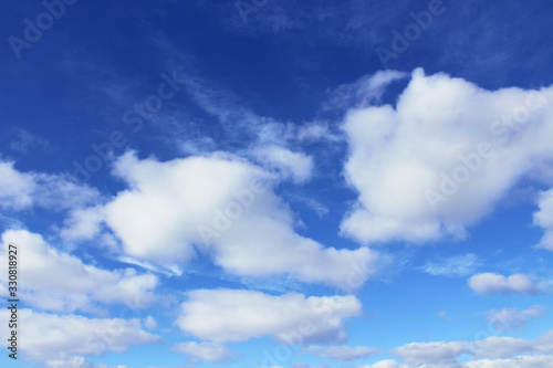 Beautiful blue sky and white cumulus clouds. Close-up. Background. Scenery.