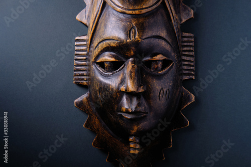 Ancient wooden african mask on a dark background