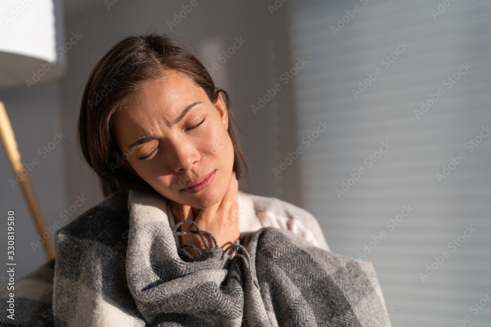 Coronavirus disease (COVID-19) symptoms are a runny nose, sore throat, cough, and fever. Corona virus illness can be more severe for some people. Asian woman with throat pain at home. Coronavirus disease (COVID-19) symptoms are a runny nose, sore throat, cough, and fever. Corona virus illness can be more severe for some people. Asian woman with throat pain at home.
