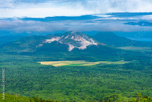 Natural landscape of Mount Io (Mount Iwo) in summer sunny day, a volcano in the Akan Volcanic Complex. The mountain was once mined for sulphur, hence its name. Teshikaga, Hokkaido, Japan photo