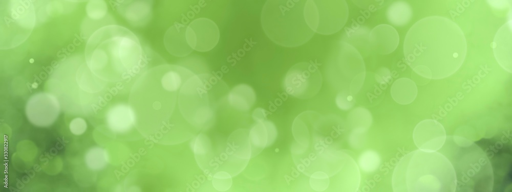 Naklejka Spring background - abstract banner - green blurred bokeh lights with copy space
